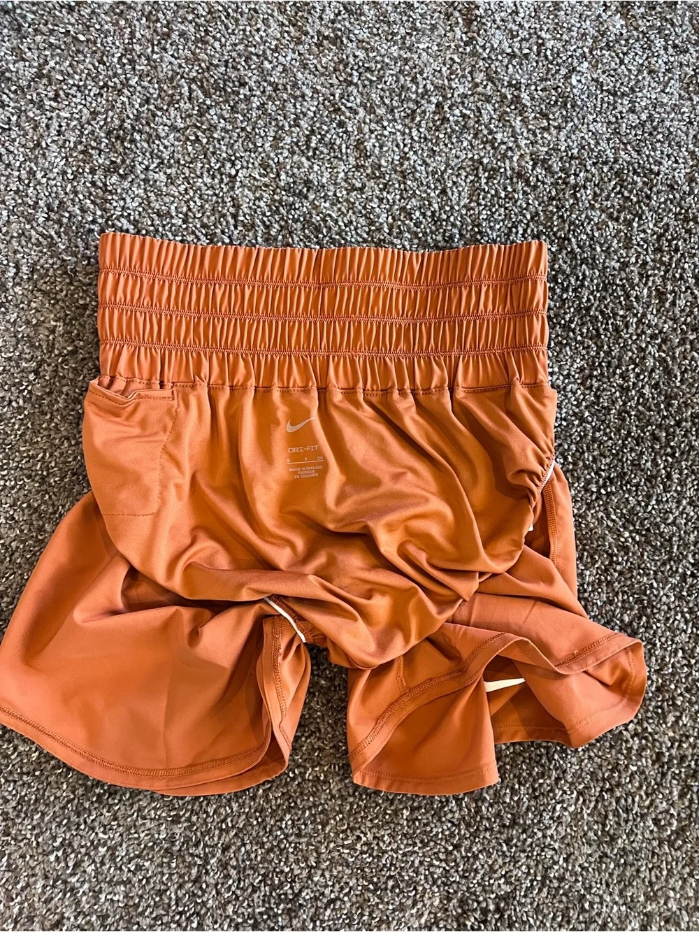 Nike Women's High-Waist Athletic Shorts in Burnt Orange with White Logos